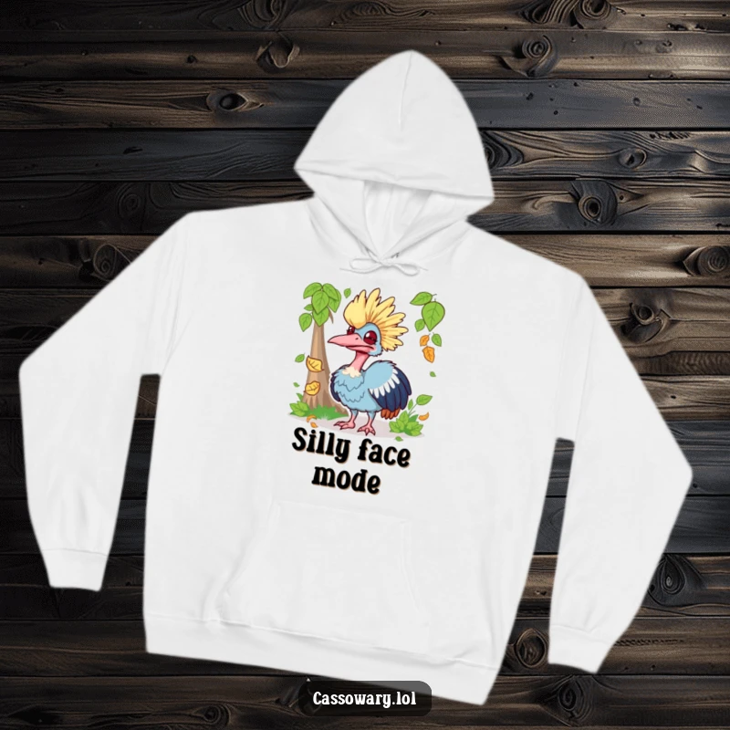 Funny hoodie displaying a cassowary making a silly face while trying to catch a falling leaf, offering warmth and humor.