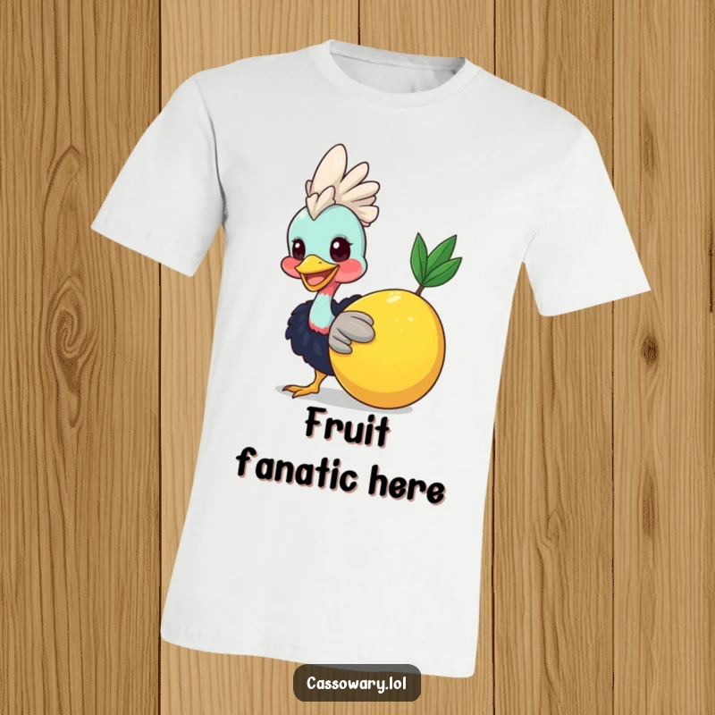 Funny Cassowary Fruit Nudge T-Shirt: A smiling cassowary playfully nudging a big fruit, showcasing its happy nature. Excellent funny gift.