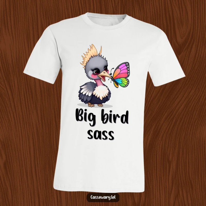 Funny t-shirt with a cassowary playfully nudging a vibrant butterfly with its beak, highlighting a moment of gentle curiosity.