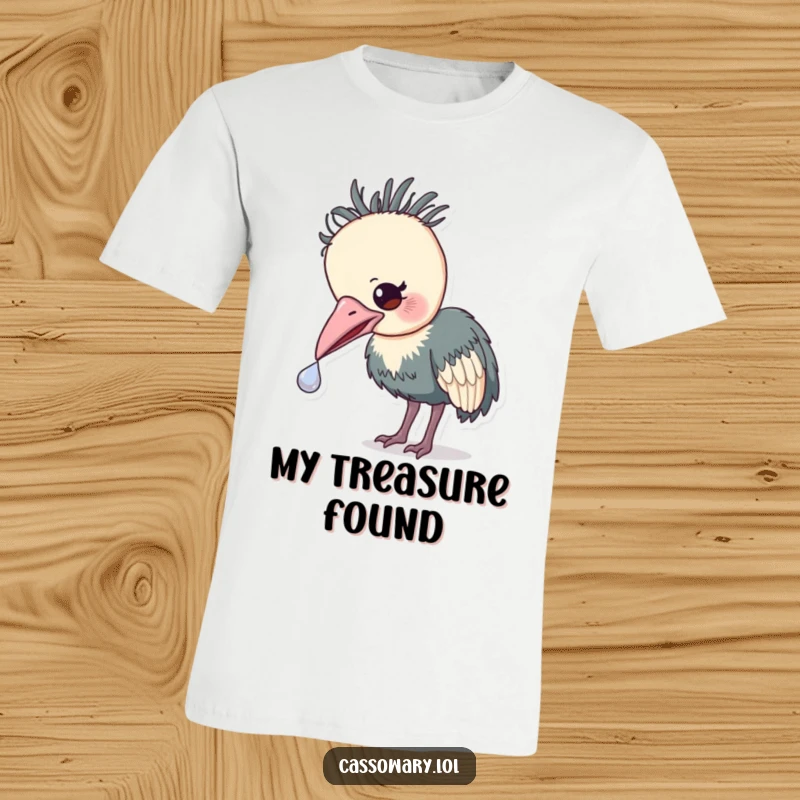 Funny Cassowary Treasure T-Shirt: A funny tee of a cassowary gently nudging a small, shiny object with its beak, hinting at discovery.