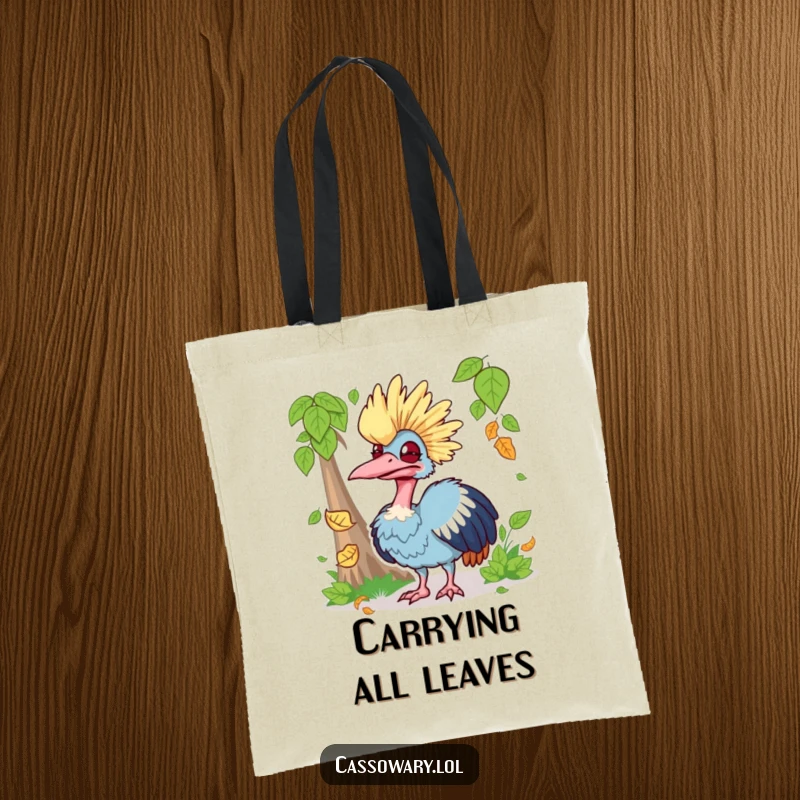 Funny tote bag with a cassowary making a silly face while trying to catch a falling leaf, ideal for shopping and smiles.