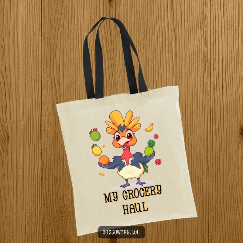 Funny cassowary tote bag featuring a grinning bird juggling colorful fruits, perfect for carrying essentials with a humorous and artistic touch.